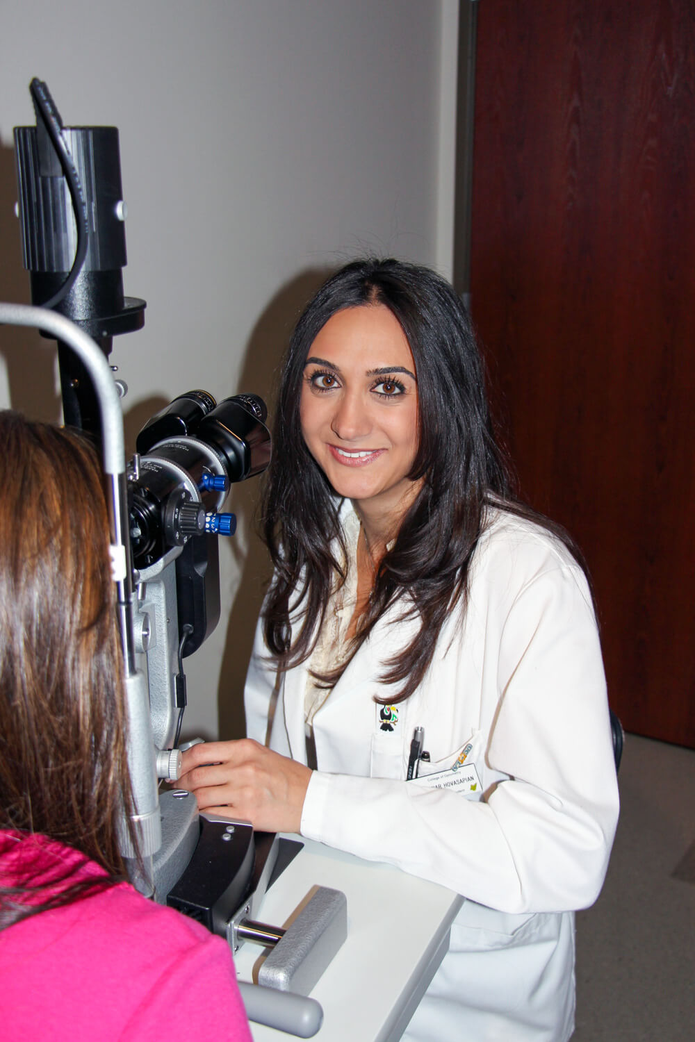 Dr. Nanar Hovasapian performing an eye examination with a patient
